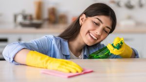 Woman buffing out scratches in soapstone countertop