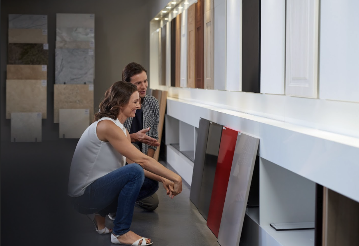 couple selecting cabinet doors and colors to match the countertop stone